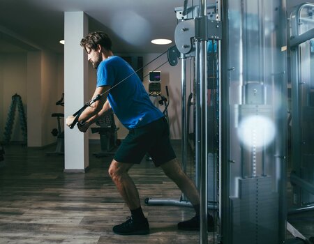 Mann trainiert im Fitnessraum