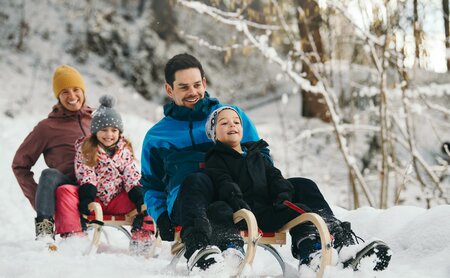 Familie beim Rodeln