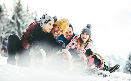 Familie beim Rodeln
